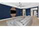 Stunning living room featuring ceiling fan, contemporary design, tile flooring, and blue accent wall at 10177 Crystal Isle Cir, Sarasota, FL 34241
