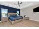 This primary bedroom features a large bed, stylish furniture, and an accent wall at 10177 Crystal Isle Cir, Sarasota, FL 34241