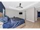 Primary bedroom featuring a spacious layout, tray ceiling, modern ceiling fan, and tile floors at 10177 Crystal Isle Cir, Sarasota, FL 34241