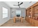 Home office featuring a spacious desk, custom built-ins, and tile floors at 10177 Crystal Isle Cir, Sarasota, FL 34241