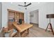 Bright office features a large desk, built-in shelving, and wood-look tile at 10177 Crystal Isle Cir, Sarasota, FL 34241