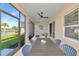 Relaxing screened patio with outdoor dining and beautiful lake views at 10177 Crystal Isle Cir, Sarasota, FL 34241