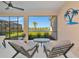 Inviting screened patio with comfortable seating and serene lake views at 10177 Crystal Isle Cir, Sarasota, FL 34241