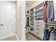 Custom walk-in closet with built-in shelving, drawers, and hanging space for organized storage at 10177 Crystal Isle Cir, Sarasota, FL 34241