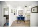 Clean dining area with white cabinets, a glass-top table, and a view into the adjacent living space at 10315 Cortez W Rd # 60-4, Bradenton, FL 34210