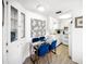 Bright dining space showcasing a glass-top table, blue chairs, and stylish decorative artwork at 10315 Cortez W Rd # 60-4, Bradenton, FL 34210