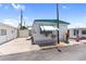 Charming mobile home featuring a teal awning, white lattice trim, and well-kept landscaping at 10315 Cortez W Rd # 60-4, Bradenton, FL 34210