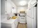 Bright kitchen features white appliances, white cabinets, and a yellow sink at 10315 Cortez W Rd # 60-4, Bradenton, FL 34210