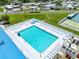 Inviting aerial view of a large community pool with surrounding lounge chairs and well-maintained grounds at 10315 Cortez W Rd # 60-4, Bradenton, FL 34210