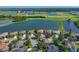 Expansive aerial view of a lakeside home in a serene community, offering a perfect blend of luxury and tranquility at 10571 Old Grove Cir, Bradenton, FL 34212
