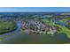 Overhead view of real estate, situated on a picturesque lake, showing off waterfront living at 10571 Old Grove Cir, Bradenton, FL 34212