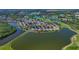 An aerial shot showcasing homes around a tranquil lake in a beautiful community at 10571 Old Grove Cir, Bradenton, FL 34212