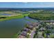 An aerial view of stunning waterfront homes with lush landscaping along the lake at 10571 Old Grove Cir, Bradenton, FL 34212