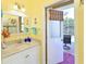 Bright bathroom with granite vanity and a door leading to the screened patio at 10571 Old Grove Cir, Bradenton, FL 34212