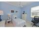 Light blue bedroom featuring a single bed, bright window, and a neutral carpet for a comfortable retreat at 10571 Old Grove Cir, Bradenton, FL 34212