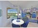 Breakfast nook with views of the pool and lake, with seating for four at a round table at 10571 Old Grove Cir, Bradenton, FL 34212