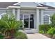 Inviting clubhouse entrance with manicured landscaping, offering a welcoming atmosphere at 10571 Old Grove Cir, Bradenton, FL 34212