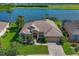 Stunning home featuring manicured lawn and lake view in a golf community, perfect for relaxed luxury living at 10571 Old Grove Cir, Bradenton, FL 34212