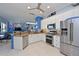 Bright kitchen features white cabinets, stainless steel appliances and granite countertops at 10571 Old Grove Cir, Bradenton, FL 34212