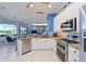Bright kitchen features white cabinets, stainless steel appliances and granite countertops at 10571 Old Grove Cir, Bradenton, FL 34212
