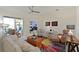 Cozy living room with stylish furnishings and access to an outdoor patio with a lake view at 10571 Old Grove Cir, Bradenton, FL 34212