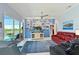 Living room with lake view, comfortable seating, and a wall-mounted television at 10571 Old Grove Cir, Bradenton, FL 34212