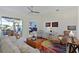 Cozy living room with stylish furnishings and access to an outdoor patio with a lake view at 10571 Old Grove Cir, Bradenton, FL 34212