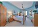 The bedroom features a four poster bed, wood furniture and a nice water view at 10571 Old Grove Cir, Bradenton, FL 34212