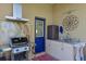 Outdoor kitchen features a built-in grill, mini fridge, stainless steel hood and granite counters at 10571 Old Grove Cir, Bradenton, FL 34212