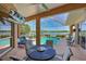 Relaxing screened-in patio with a pool, seating area, and a beautiful lake view at 10571 Old Grove Cir, Bradenton, FL 34212