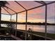 Relax by the pool on the screened patio with breathtaking sunset and lake views, creating a serene retreat at 10571 Old Grove Cir, Bradenton, FL 34212