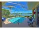 Enjoy outdoor living with a screened pool overlooking the lake, creating a private and scenic retreat at 10571 Old Grove Cir, Bradenton, FL 34212