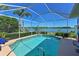 Inviting screened-in pool offers stunning lake views and a tranquil backyard oasis at 10571 Old Grove Cir, Bradenton, FL 34212