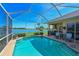 Gorgeous screened-in pool with lake view, complemented by a covered patio with outdoor kitchen at 10571 Old Grove Cir, Bradenton, FL 34212