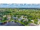 Expansive aerial view of a community featuring lush greenery, serene lakes, and beautiful homes at 11250 Rivers Bluff Cir, Lakewood Ranch, FL 34202