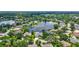 Overhead view of homes surrounding lake, showcasing community's layout and waterside properties at 11250 Rivers Bluff Cir, Lakewood Ranch, FL 34202