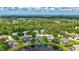 Panoramic aerial shot showcasing homes nestled in a lush, green landscape with a peaceful lake at 11250 Rivers Bluff Cir, Lakewood Ranch, FL 34202
