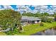 Beautiful waterfront property with a screened-in lanai, manicured lawn, and lush landscaping at 11250 Rivers Bluff Cir, Lakewood Ranch, FL 34202