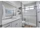 Bathroom features a white vanity with granite countertop and a glass-enclosed shower at 11250 Rivers Bluff Cir, Lakewood Ranch, FL 34202