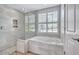 Stylish bathroom features a soaking tub with jets and a walk-in shower with decorative tile at 11250 Rivers Bluff Cir, Lakewood Ranch, FL 34202