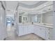 Bright bathroom featuring an extended vanity, plentiful storage, and large mirrors at 11250 Rivers Bluff Cir, Lakewood Ranch, FL 34202