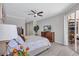 A tranquil bedroom showcases natural light, neutral tones, and a ceiling fan for added comfort at 11250 Rivers Bluff Cir, Lakewood Ranch, FL 34202