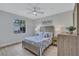 The bedroom includes wood look floors, a ceiling fan and a matching dresser and nightstand at 11250 Rivers Bluff Cir, Lakewood Ranch, FL 34202