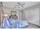 A bedroom boasts wood floors, closet doors, a ceiling fan and dresser at 11250 Rivers Bluff Cir, Lakewood Ranch, FL 34202