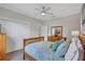 Bedroom with wood floors, a ceiling fan, closet doors and a matching dresser at 11250 Rivers Bluff Cir, Lakewood Ranch, FL 34202