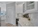 Butler's pantry features a wine cooler, glass cabinets, and neutral color scheme at 11250 Rivers Bluff Cir, Lakewood Ranch, FL 34202