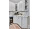 Bright Butler's pantry with corner cabinets, backsplash, wine cooler and decor at 11250 Rivers Bluff Cir, Lakewood Ranch, FL 34202