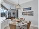 Dining area featuring a modern fireplace and views of the pool and outdoor seating at 11250 Rivers Bluff Cir, Lakewood Ranch, FL 34202