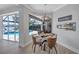 Cozy dining area with a modern fireplace and serene pool view at 11250 Rivers Bluff Cir, Lakewood Ranch, FL 34202