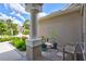 Home exterior featuring a covered entryway with elegant columns and lush landscaping around the walkway at 11250 Rivers Bluff Cir, Lakewood Ranch, FL 34202